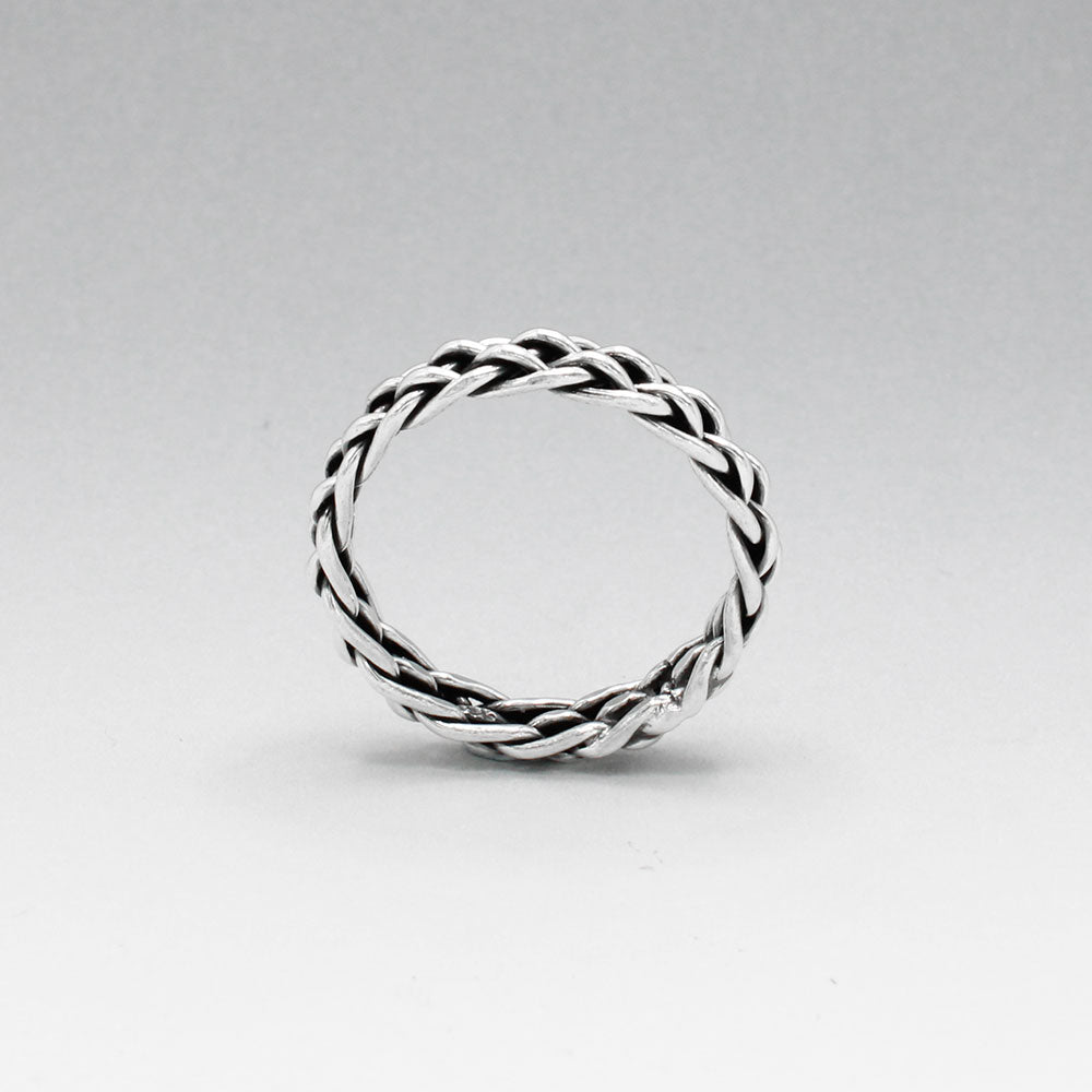 Aran - Thread Weave Oxidised Silver Ring A unisex piece designed to seamlessly blend style and substance. This ring measures 5mm wide and 3mm thick, crafted from solid oxidised sterling silver. Made with .925 sterling silver, the Aran ring offers both durability and timeless elegance. Its versatile design makes it a perfect accessory for any occasion, suitable for both men and women.