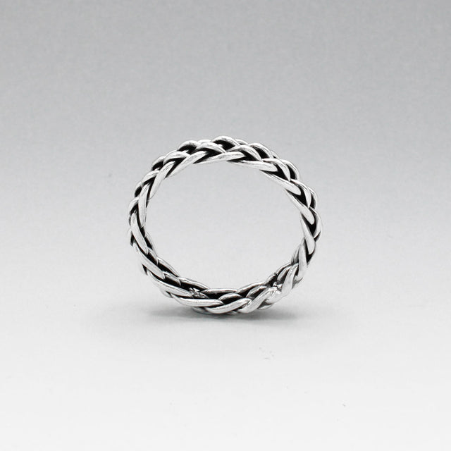Aran - Thread Weave Oxidised Silver Ring  A unisex piece designed to seamlessly blend style and substance. This ring measures 5mm wide and 3mm thick, crafted from solid oxidised sterling silver.  Made with .925 sterling silver, the Aran ring offers both durability and timeless elegance. Its versatile design makes it a perfect accessory for any occasion, suitable for both men and women.