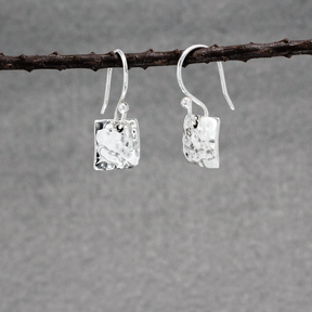 Small Artemis Hammered Square Silver Earrings Dangle Details: Dimensions: 10 mm long by 10 mm wide (approximately 3/8 inches long by 3/8 inches wide) Sterling silver French wire Material: .950 sterling silver Finish: Hammered silver