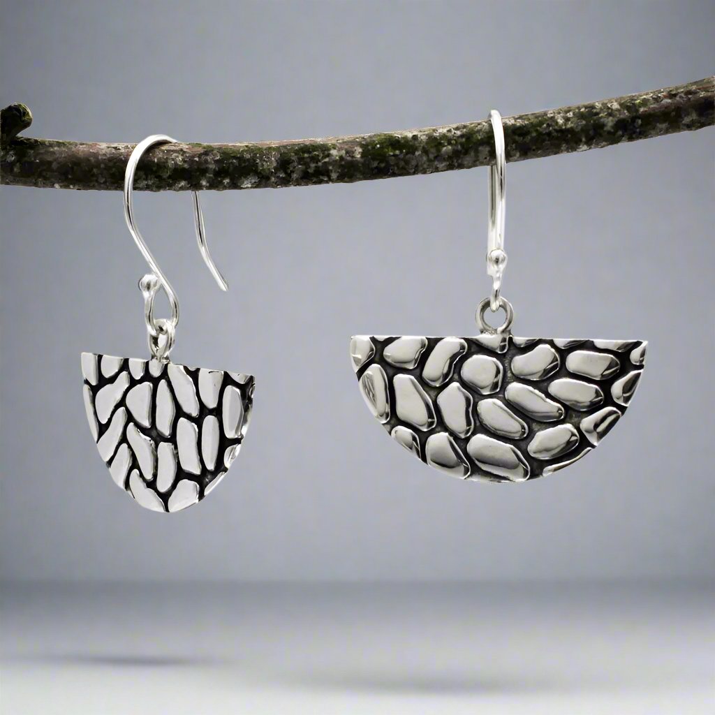 The Camila Abanico Oxidised Silver Earrings are crafted from .950 sterling silver with an oxidized finish. Their fan-shaped design offers a distinctive look, perfect for casual or formal wear.

Material: .950 sterling silver with an oxidized finish
Dimensions:
Earring Size: 25mm wide by 13mm high (15/16 inches by 1/2 inch)
Length: 1 3/16 inches long from the top of the ear wire
Design: Dangle style with sterling silver French wire
A unique design with a modern oxidized finish for added character.

#silver