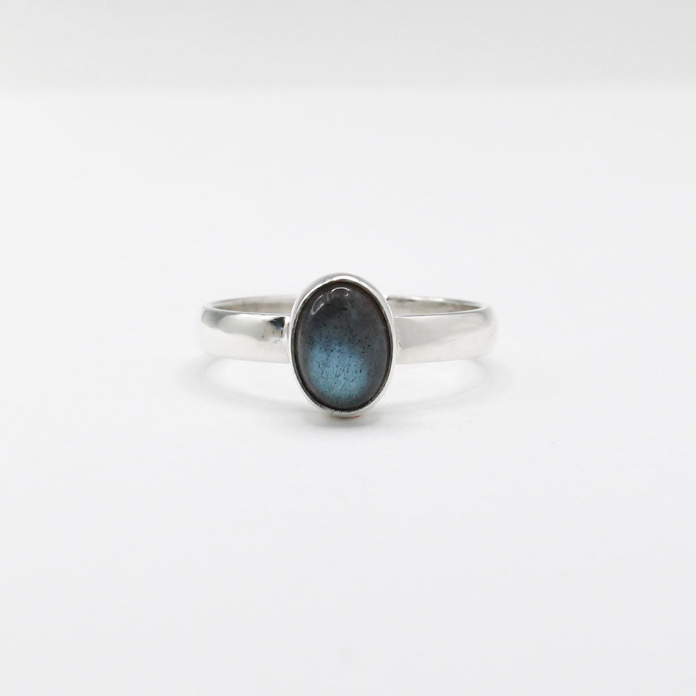 Labradorite is a captivating gemstone known for its unique optical properties. Labradorite is famous for its iridescence, often displaying a stunning play of colours, known as labradorescence. Candy - Small Oval Labradorite Cabochon Silver Ring. Ireland jewellery.