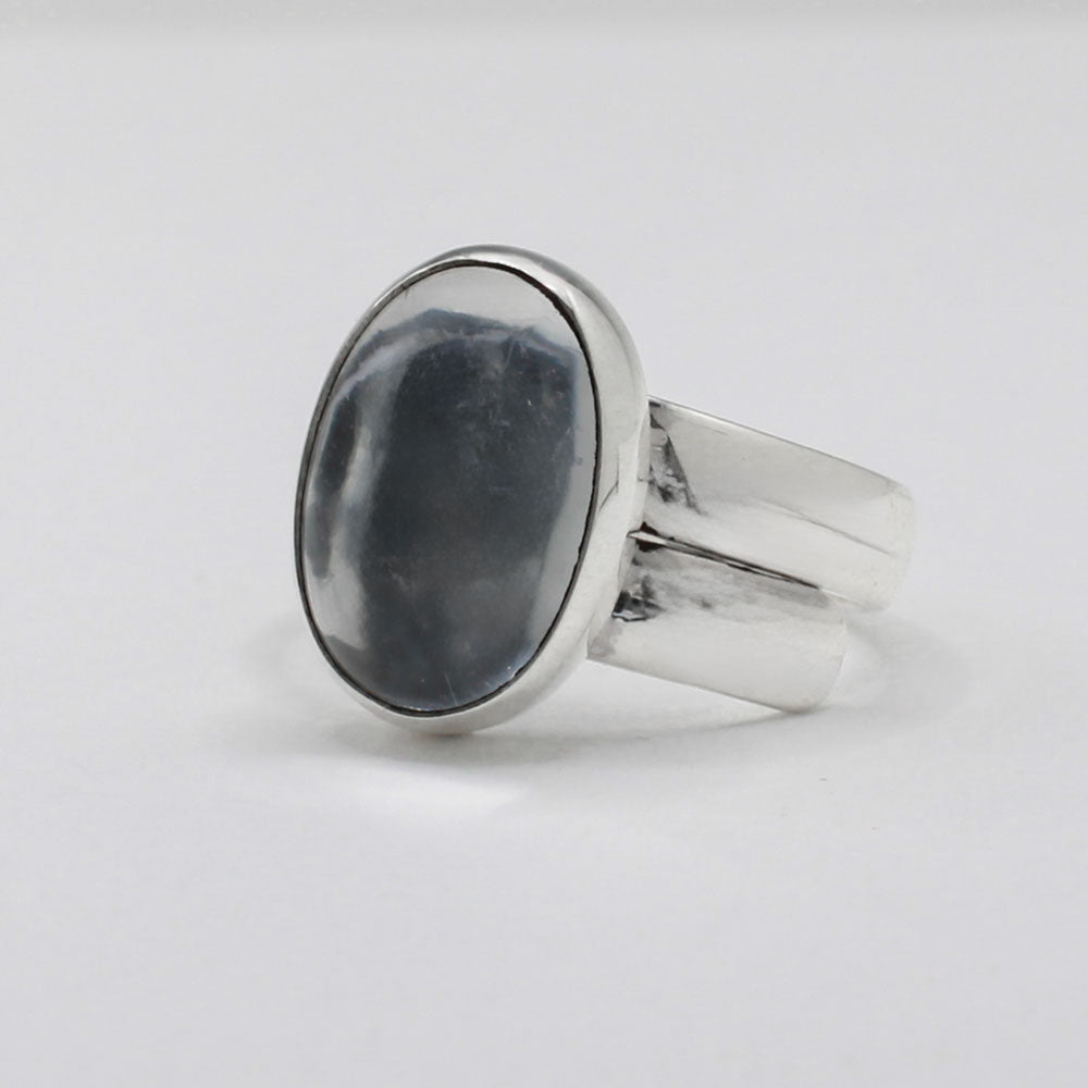 Candy - Oval Hematite Cabochon Silver Ring - Adjustable. Jewellery shop ireland.Hematite typically has a metallic gray to black colour with a shiny, reflective surface, giving it a distinctive, mirror-like appearance. The stone has a high metallic luster. Traditionally, hematite is believed to have grounding and protective qualities, often used in metaphysical practices to enhance focus, courage, and balance.