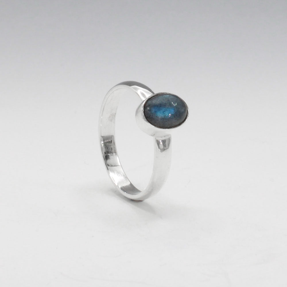 Labradorite is a captivating gemstone known for its unique optical properties. Labradorite is famous for its iridescence, often displaying a stunning play of colours, known as labradorescence. Candy - Small Oval Labradorite Cabochon Silver Ring. Ireland jewellery.