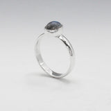 Labradorite is a captivating gemstone known for its unique optical properties. Labradorite is famous for its iridescence, often displaying a stunning play of colours, known as labradorescence. Candy - Small Oval Labradorite Cabochon Silver Ring. Ireland jewellery.