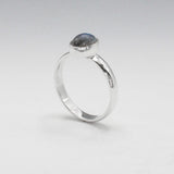 Labradorite is a captivating gemstone known for its unique optical properties. Labradorite is famous for its iridescence, often displaying a stunning play of colours, known as labradorescence. Candy - Small Oval Labradorite Cabochon Silver Ring. Ireland jewellery.