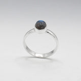 Labradorite is a captivating gemstone known for its unique optical properties. Labradorite is famous for its iridescence, often displaying a stunning play of colours, known as labradorescence. Candy - Small Oval Labradorite Cabochon Silver Ring. Ireland jewellery.