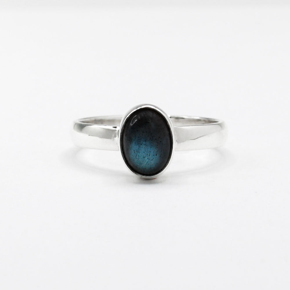 Labradorite is a captivating gemstone known for its unique optical properties. Labradorite is famous for its iridescence, often displaying a stunning play of colours, known as labradorescence. Candy - Small Oval Labradorite Cabochon Silver Ring. Ireland jewellery.