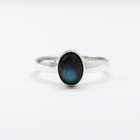 Labradorite is a captivating gemstone known for its unique optical properties. Labradorite is famous for its iridescence, often displaying a stunning play of colours, known as labradorescence. Candy - Small Oval Labradorite Cabochon Silver Ring. Ireland jewellery.