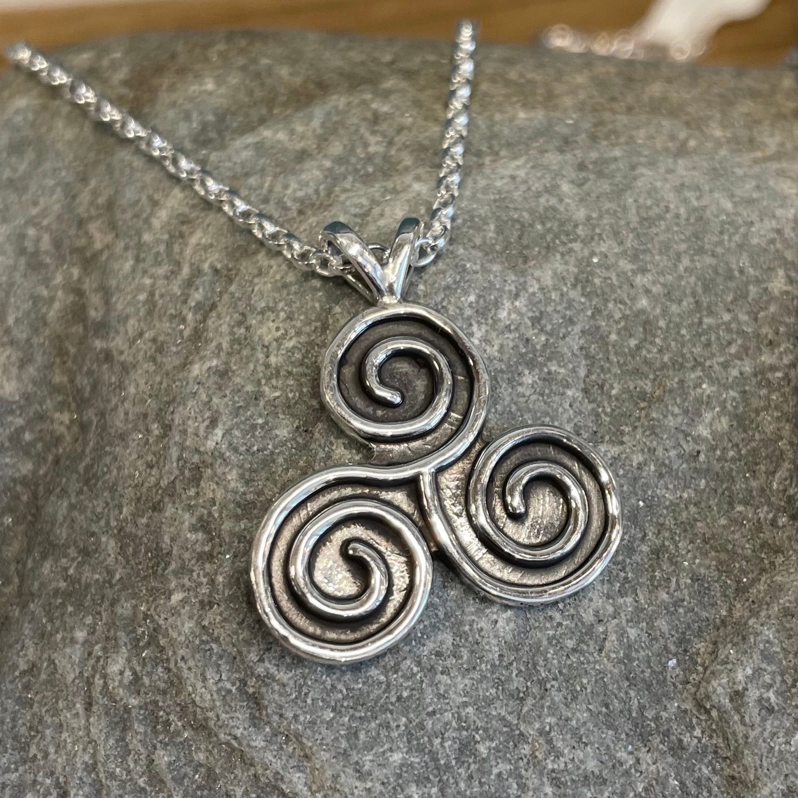 This stunning Celtic - Triskel Oxidised Silver Pendant measures 21 mm wide and 24 mm from the top of the bail. Included is a 1.7 mm Sterling Silver Rolo Chain with a round spring clasp for easy wear.