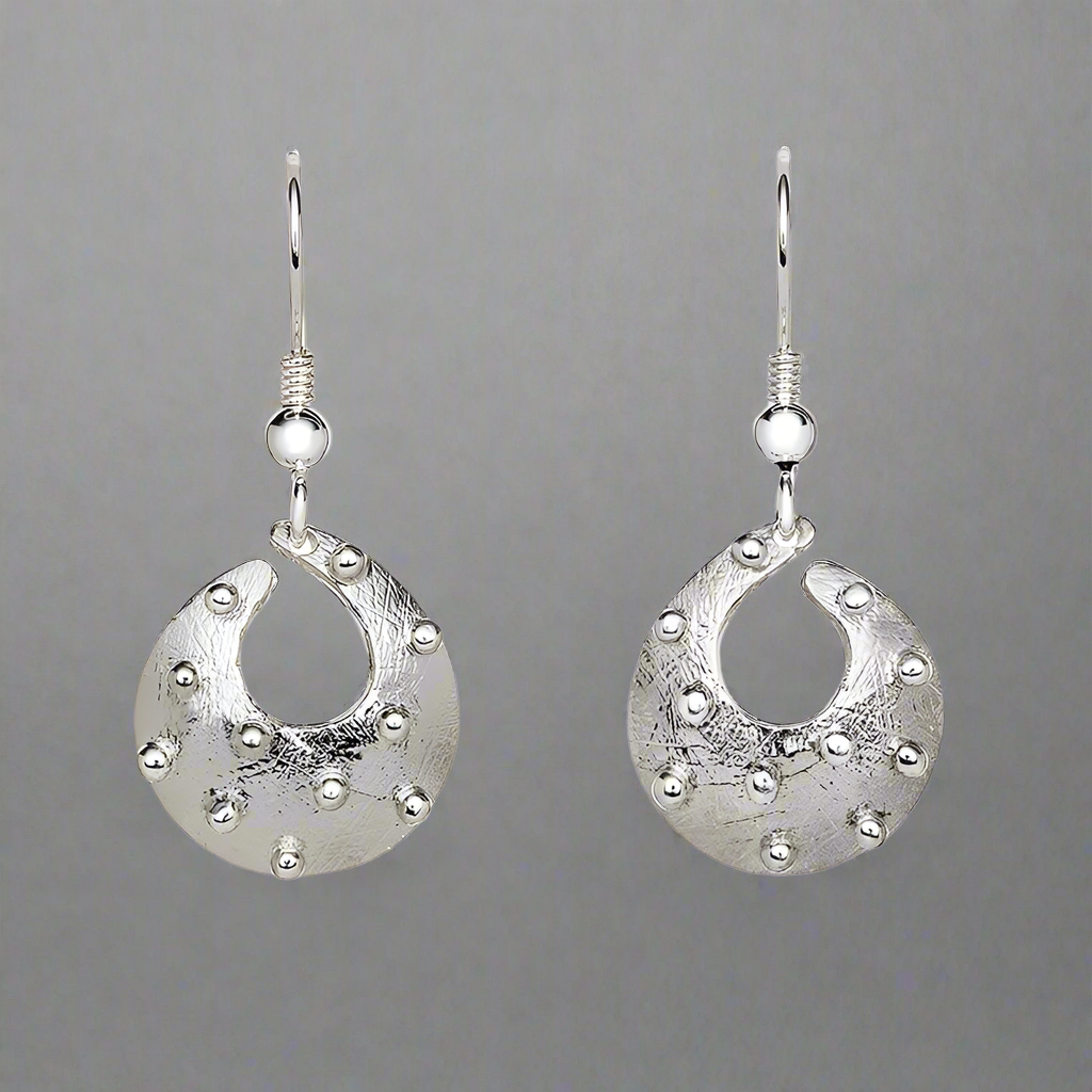 Cloicin, from the Irish for small stone, was his very first collection and still one of his best selling today. Inspired by the stony shoreline of Carlingford Lough the collection features an etched surface representing the sandy surface that all the stones and pebbles lie on. These delicate earrings are ideal for everyday wear.