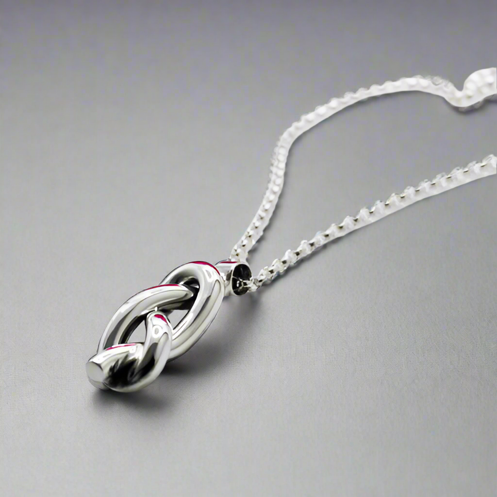 Aran - Single Open Knot Silver Pendant Ireland Jewellery West Cork

Inspired by timeless nautical knots. This sculpted pendant is handcrafted in solid sterling silver. Its open knot design, combined with a highly polished finish, makes it a versatile piece for daily wear or special occasions. Perfect Christmas Gift
Details:
* Material: Handmade solid sterling silver
* Dimensions: 12mm wide x 34mm high (from the top of the bail) x 8mm thick (approx. 1/2" x 1 3/8" x 5/16")