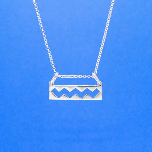 Wild Atlantic Way Silver Pendant. This stunning piece boasts dimensions of 25mm in width and 6mm in height, with a measurement of 12mm from the top of the bails. Its bail is designed to fit up to a 2.5mm chain. This pendant pays homage to the enchanting Wild Atlantic Way, making it an essential addition to any jewellery collection.