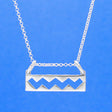 Wild Atlantic Way Silver Pendant. This stunning piece boasts dimensions of 25mm in width and 6mm in height, with a measurement of 12mm from the top of the bails. Its bail is designed to fit up to a 2.5mm chain. This pendant pays homage to the enchanting Wild Atlantic Way, making it an essential addition to any jewellery collection.