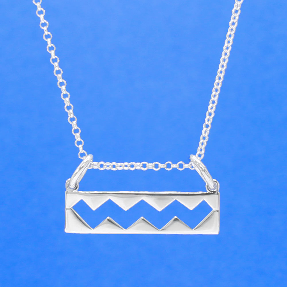 Wild Atlantic Way Silver Pendant. This stunning piece boasts dimensions of 25mm in width and 6mm in height, with a measurement of 12mm from the top of the bails. Its bail is designed to fit up to a 2.5mm chain. This pendant pays homage to the enchanting Wild Atlantic Way, making it an essential addition to any jewellery collection.