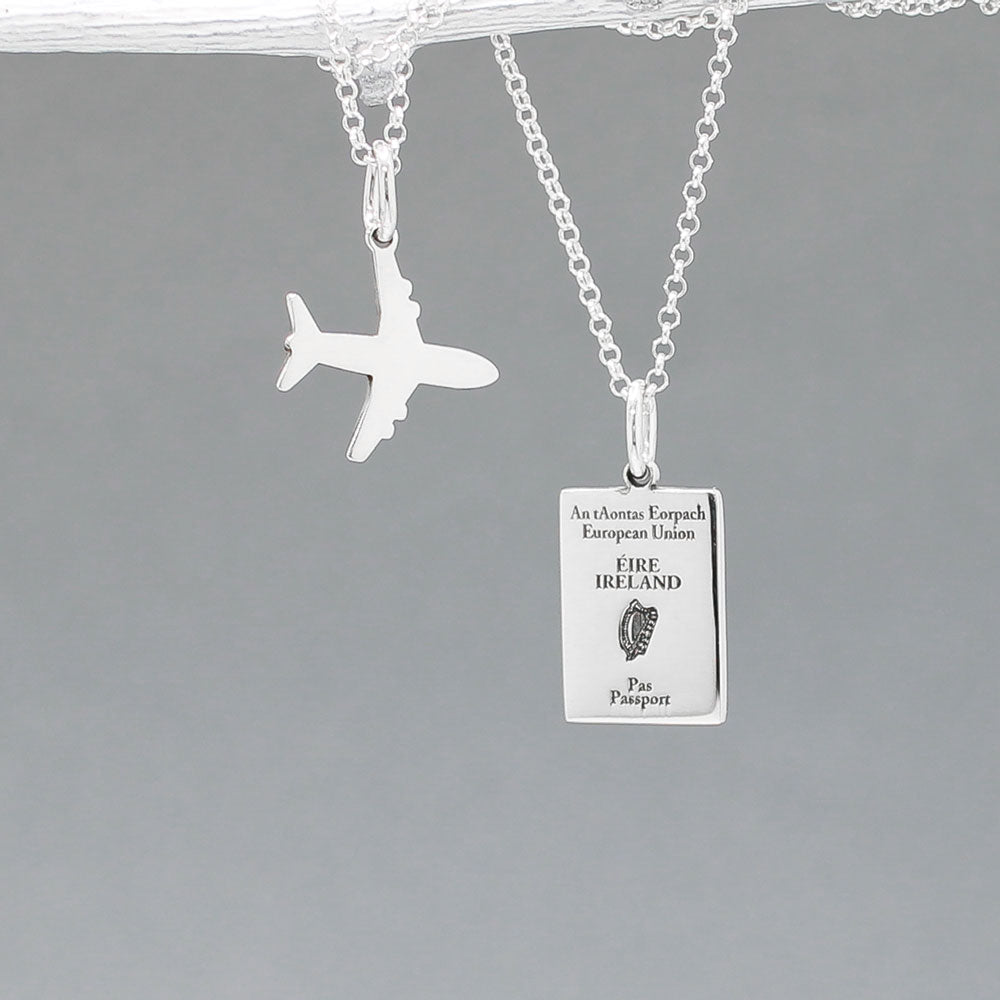 Our&nbsp;Irish Passport Mini Replica Silver Pendant captures all the intricate details of an Irish passport cover. Meticulously crafted from sterling silver, it boasts a dazzling high-polished finish. 🇮🇪✈️  Dimensions: Passport: 10mm wide by 14mm high Airplane: 14mm wide by 14mm high Bail: Fits up to a 2.5mm chain for versatile wear. Chain: Includes a 1.4mm sterling silver belcher Rolo chain, available in various lengths to suit your style preference.