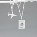 Our Mexican Passport Mini Replica Silver Pendant captures the intricate details of a Mexican passport cover, meticulously crafted from sterling silver with a high-polished finish.  Dimensions: Passport: 10mm wide by 14mm high; Airplane: 14mm wide by 14mm high. Bail: Fits up to a 2.5mm chain for versatile wear. Chain: Includes a 1.4mm sterling silver belcher Rolo chain, available in various lengths.