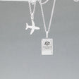 Our Australian Passport Mini Replica Silver Pendant captures all the intricate details of a passport cover. Meticulously crafted from sterling silver, it boasts a dazzling high-polished finish.  Dimensions: Passport: 10mm wide by 14mm high Airplane: 14mm wide by 14mm high Bail: Fits up to a 2.5mm chain for versatile wear. Chain: Includes a 1.4mm sterling silver belcher Rolo chain, available in various lengths to suit your style preference.
