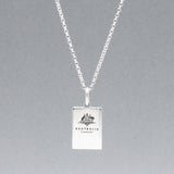 Our Australian Passport Mini Replica Silver Pendant captures all the intricate details of a passport cover. Meticulously crafted from sterling silver, it boasts a dazzling high-polished finish.  Dimensions: Passport: 10mm wide by 14mm high Airplane: 14mm wide by 14mm high Bail: Fits up to a 2.5mm chain for versatile wear. Chain: Includes a 1.4mm sterling silver belcher Rolo chain, available in various lengths to suit your style preference.