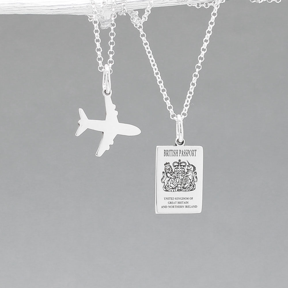 Our&nbsp;British Passport Mini Replica Silver Pendant captures all the intricate details of a British passport cover. Meticulously crafted from sterling silver, it boasts a dazzling high-polished finish.  Dimensions: Passport: 10mm wide by 14mm high Airplane: 14mm wide by 14mm high Bail: Fits up to a 2.5mm chain for versatile wear. Chain: Includes a 1.4mm sterling silver belcher Rolo chain, available in various lengths to suit your style preference.