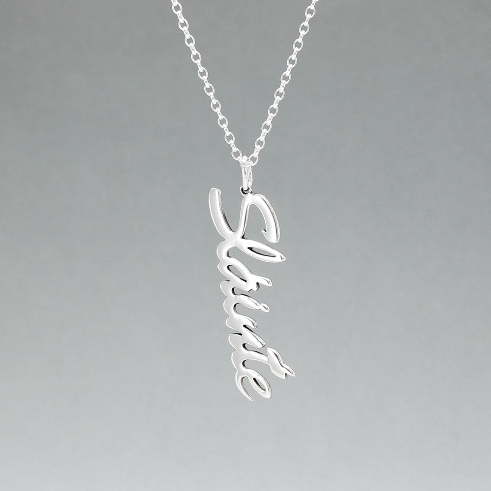 Eire - Sláinte (Health) Silver Pendant  Dimensions: 12mm wide x 37mm long, 1mm thick Chain: 1.7mm sterling silver rolo chain included Material: Made with sterling silver Design: Featuring the word "Sláinte" in italic font Style: Unisex Celebrate health and well-being with our elegant Eire - Sláinte Silver Pendant. This beautifully crafted piece is perfect for anyone who appreciates fine Irish jewellery. Select chain length below.