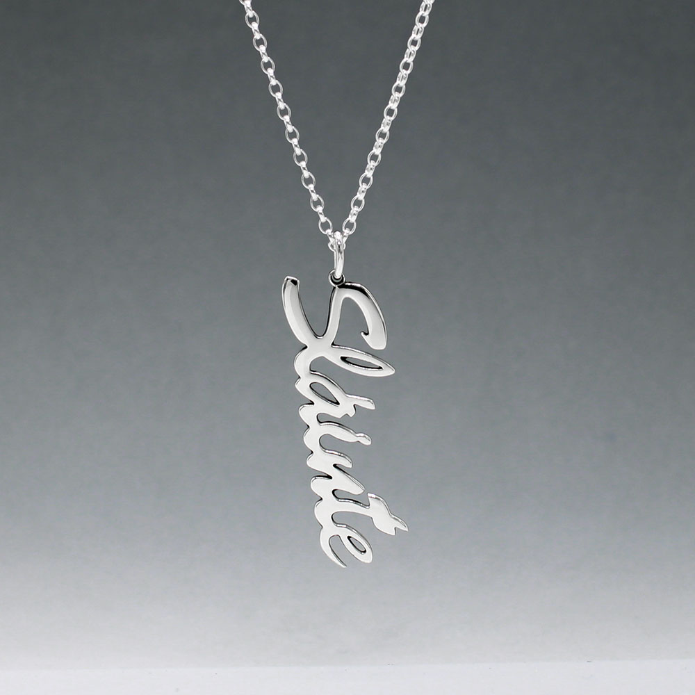 Eire - Sláinte (Health) Silver Pendant  Dimensions: 12mm wide x 37mm long, 1mm thick Chain: 1.7mm sterling silver rolo chain included Material: Made with sterling silver Design: Featuring the word "Sláinte" in italic font Style: Unisex Celebrate health and well-being with our elegant Eire - Sláinte Silver Pendant. This beautifully crafted piece is perfect for anyone who appreciates fine Irish jewellery. Select chain length below.