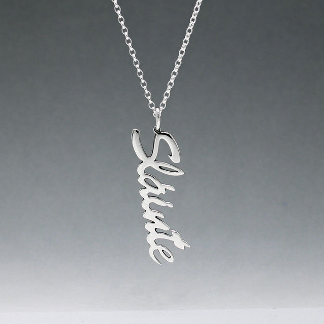 Eire - Sláinte (Health) Silver Pendant  Dimensions: 12mm wide x 37mm long, 1mm thick Chain: 1.7mm sterling silver rolo chain included Material: Made with sterling silver Design: Featuring the word "Sláinte" in italic font Style: Unisex Celebrate health and well-being with our elegant Eire - Sláinte Silver Pendant. This beautifully crafted piece is perfect for anyone who appreciates fine Irish jewellery. Select chain length below.