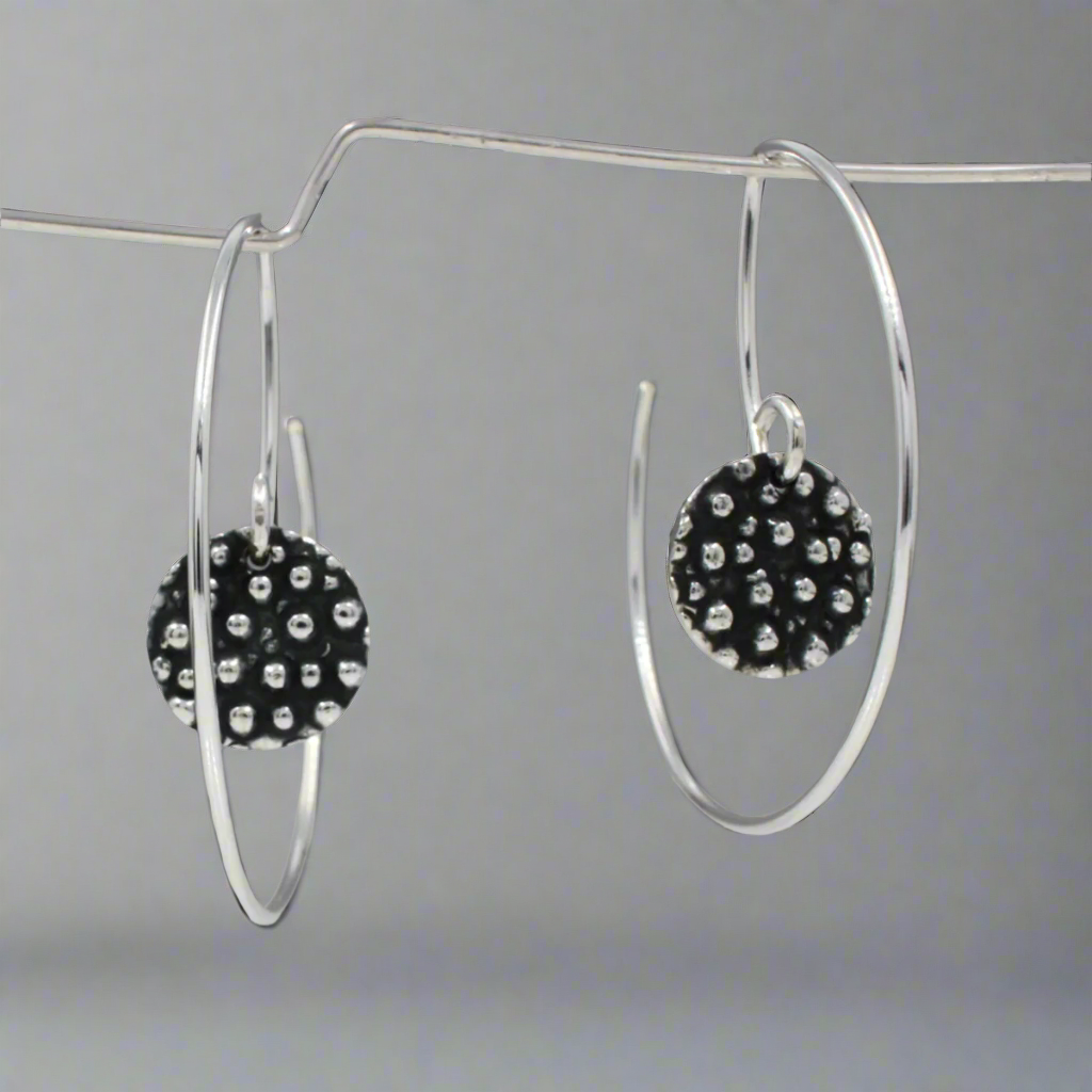 Elevate your accessory collection with the Firmament - Small Disc Oxidised Reverse Hoop Silver Earrings. These stunning earrings feature a unique design that combines elegance and modern flair. Croí Kinsale Jewellery, located in the heart of Kinsale, to discover this beautiful piece and more!