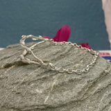 Double Twig with Chain Silver Bracelet  Width: 20mm at its widest point Twigs: Each measures 5mm at its widest point, sterling silver cast with a highly polished finish Chain: 3.5mm silver chain with a lobster clasp Length: Select your preferred bracelet length below&nbsp; Kathleen Holland Jewellery