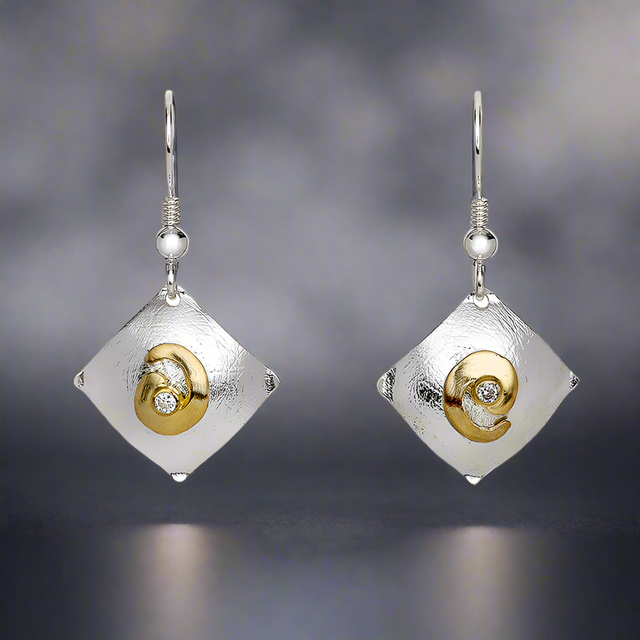Celebrate timeless symbolism with Garrett Mallon’s contemporary take on the classic Celtic Spiral. A nod to one of Celtic culture’s oldest symbols, representing the sun or ethereal energy, these earrings blend heritage with a modern aesthetic. Their simple yet stylish design makes them perfect for everyday wear, while the textured finish and shimmering accents add a touch of sophistication.