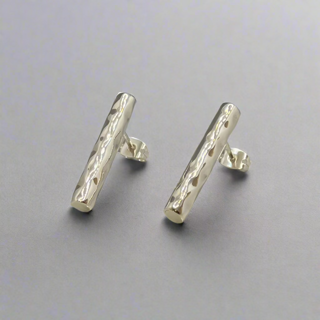 Moíneir Bamboo Stick Silver Earrings, a perfect blend of modern design and artisanal craftsmanship. Handcrafted from .950 sterling silver, these earrings showcase a stunning hammered texture that reflects light beautifully, adding a unique touch to your look.