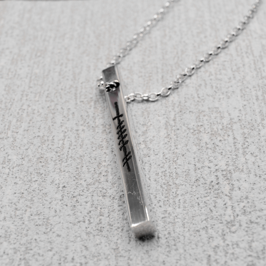 Our EIRE - Ogham Grá &amp; Wild Atlantic Way Sign Silver Bar Pendant beautifully captures the essence of "I ❤️ the Wild Atlantic Way” with intricate Ogham script spelling out the word Grá (Love) on one side and showcasing a Wild Atlantic Way Sign on the other.