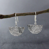 Transform your style with the&nbsp;Saha DECO Abanico Oxidised Silver Earrings. Inspired by Art Deco elegance, these handcrafted earrings feature a whimsical fan-shaped design with a weaved embossed pattern. The oxidised finish highlights the intricate details, creating a striking contrast with the polished silver. Flirty yet timeless, these earrings are perfect for everyday wear or a touch of glamour on special occasions. Ireland jewellery