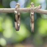 The Saha Geometric Hammered Hoop Silver Earrings exude understated elegance with their minimalist and modern design. These handcrafted sterling silver hoops feature a beautifully hammered texture on both sides, complemented by a polished gloss finish on the front. Perfect for cocktail parties or daily wear, they offer a timeless charm to suit any occasion. ireland gifts jewellery 