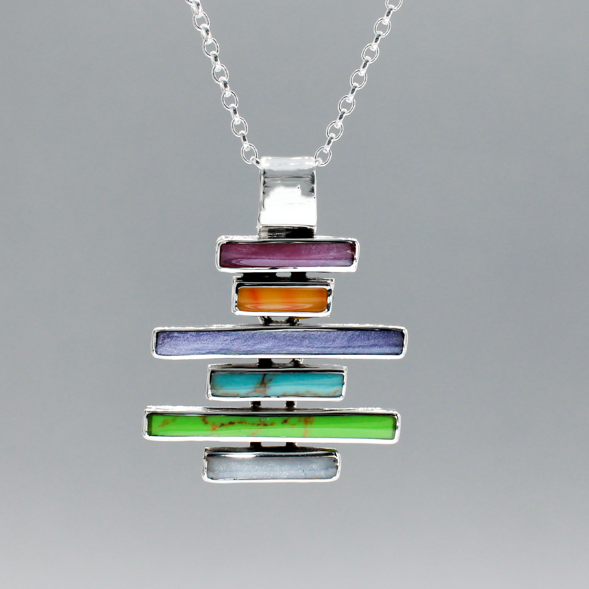Sleveen's Multi-coloured Kinsale Steps Silver Pendant is an awe-inspiring blend of style and quality - measuring 26mm wide and 33mm high, made with .925 sterling silver. The adjustable 2.5mm silver Rolo chain (16"-18") adds a special touch that brings to life the rainbow of colours found in the iconic houses of Kinsale. Best of all, it's fitted with a 6mm bail for a perfect fit.