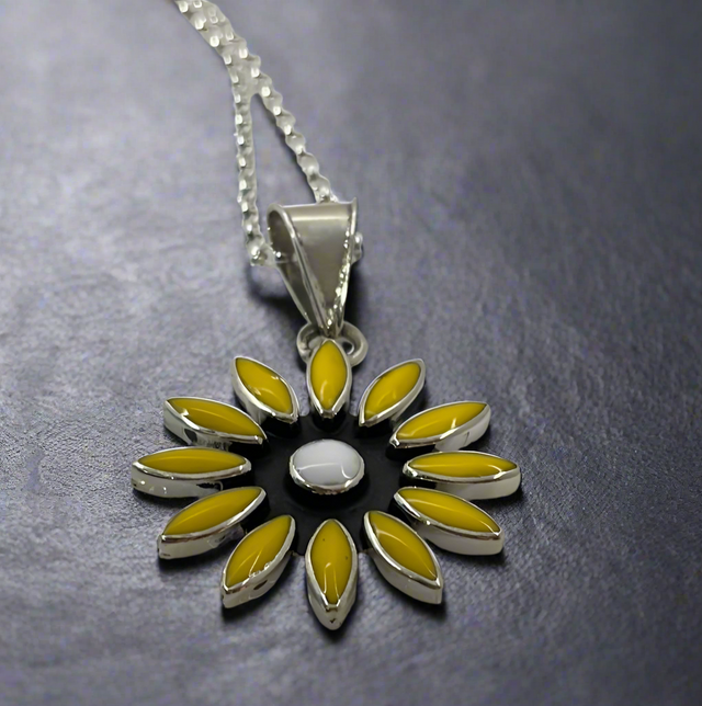 Sleveen - Daisy Flower with Yellow Resin Silver Pendant Ireland Jewellery. A striking and vibrant piece, the&nbsp;Sleveen Daisy Flower with Yellow Resin Silver Pendant is perfect for adding a splash of colour to your jewellery collection. Inspired by the colourful houses of Kinsale, this pendant features a bold square design with beautiful mosaic resin inlays that capture the town's vibrant charm.