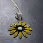 Sleveen - Daisy Flower with Yellow Resin Silver Pendant Ireland Jewellery. A striking and vibrant piece, the&nbsp;Sleveen Daisy Flower with Yellow Resin Silver Pendant is perfect for adding a splash of colour to your jewellery collection. Inspired by the colourful houses of Kinsale, this pendant features a bold square design with beautiful mosaic resin inlays that capture the town's vibrant charm.