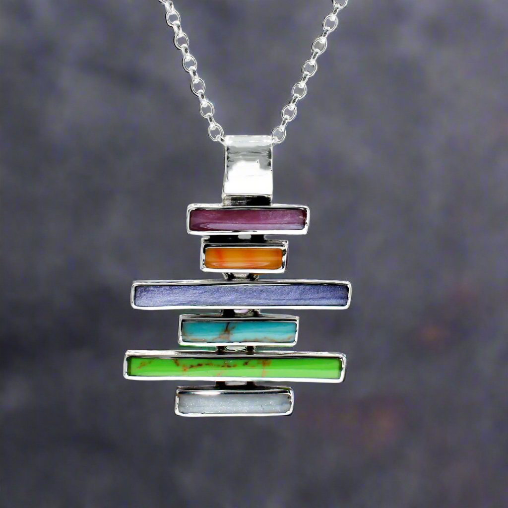 Sleveen Kinsale Steps Multi-Coloured Mosaic Resin Silver Pendant. Add a vibrant splash of Kinsale’s iconic charm to your look with the&nbsp;Sleveen - Kinsale Steps Multi-Coloured Mosaic Resin Silver Pendant. This stunning piece draws inspiration from the colourful seaside houses of Kinsale, beautifully captured in a mosaic design. Handcrafted from .925 sterling silver, it offers both style and quality, making it the perfect standout accessory.