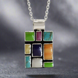 Sleveen Rectangle With Multi-Coloured-Mosaic-Resin-Pendant Ireland jewellery silver. Sleveen's&nbsp;Rectangle with Multi-Coloured Mosaic Resin Silver Pendant is an exquisite piece of jewellery that makes a bold statement. Inspired by the lively and picturesque hues of Kinsale’s iconic houses, this pendant features a striking mosaic design set in .925 sterling silver.