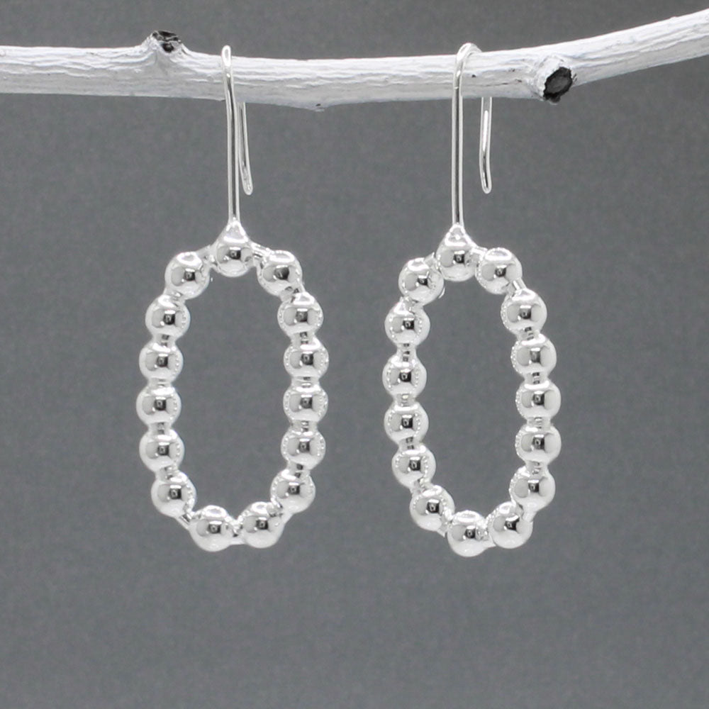 These handmade, sterling silver dangle earrings are a perfect blend of elegance and modern design. Features:  Oblong measures 17mm wide by 27mm high 4mm thick 40mm long from the top of the ear wire Made from sterling silver Handcrafted Highly polished finish for a brilliant shine Ideal for any occasion, these earrings add a touch of sophistication to any outfit.