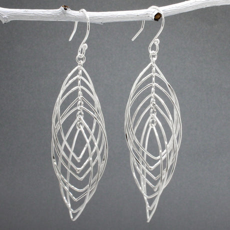 Tara - Mobile Multi Layered Leaf Shaped Wire Silver Earrings - Dangle  Design: Seven wire leaf-shaped pieces interconnected, creating an organic cascading leaves design Movement: Rotates when worn, adding whimsical and dynamic movement Features: Lightweight, highly polished silver Fastening: Sterling silver French wire Measurements: Width: 21 MM at its widest point Length: 66 MM from the top of the French wire