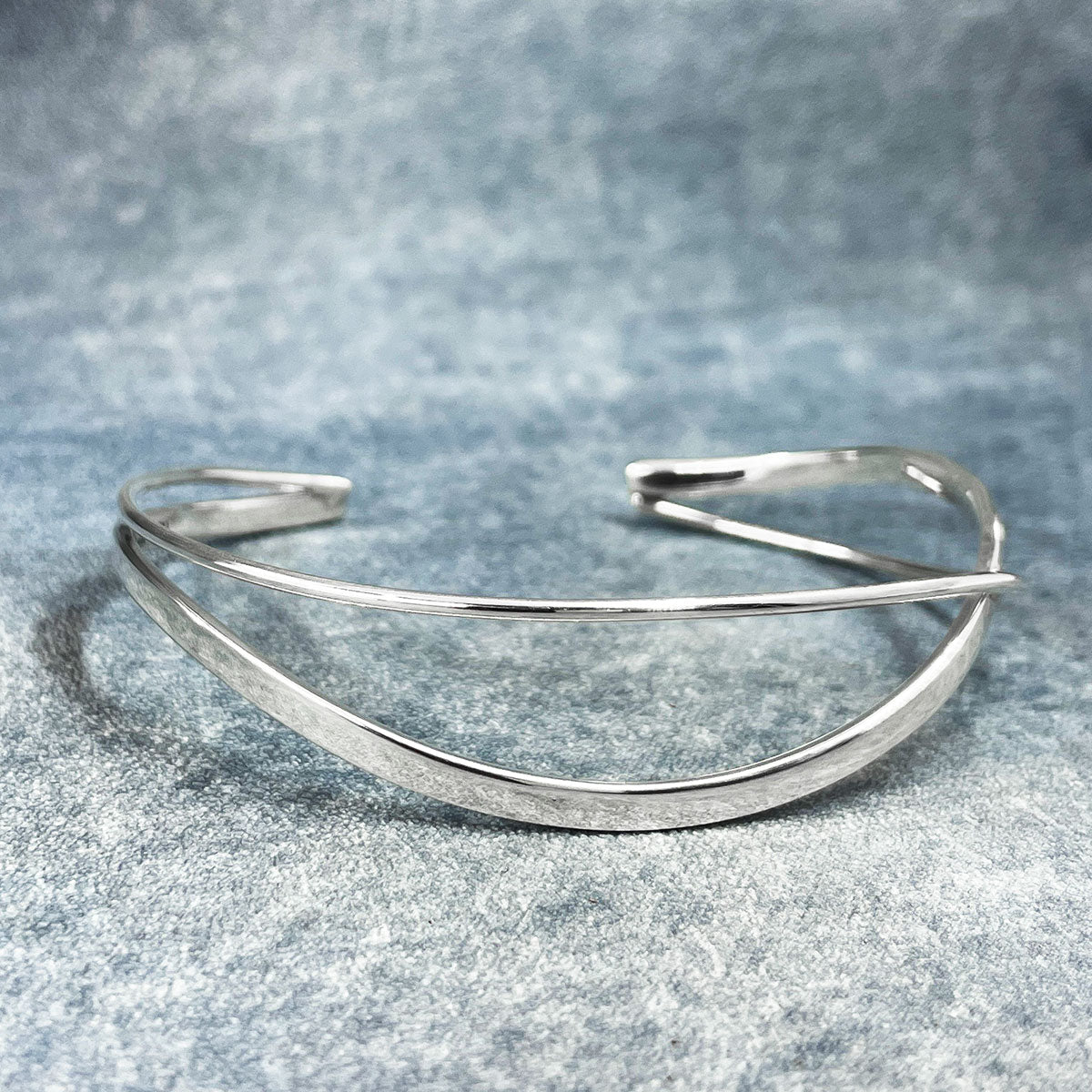 Uisce - Double Wave Cuff Silver Bracelet Curated and designed by Emilio Sotelo Jewelry for Croi Kinsale Jewellery in Kinsale West Cork Ireland Europe. Find exceptional handmade silver and gold jewellery at affordable prices for birthday gifts and Christmas presents. Handcrafted Silver jewelry. Find the best affordable jewellery