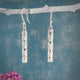 Moíneir Bamboo Stick Silver Earrings, a stunning fusion of modern design and artisanal craftsmanship. Handcrafted from .950 sterling silver, these dangle earrings feature a beautiful hammered texture that catches the light, adding a unique and eye-catching element to your look.