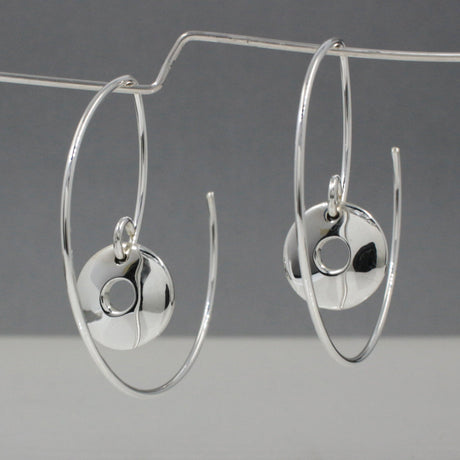 Artemis - Small Off-Center Disc Reverse Hoop Silver Earrings Curated and designed by Emilio Sotelo Jewelry for Croi Kinsale Jewellery in Kinsale West Cork Ireland Europe. Find exceptional handmade silver and gold jewellery at affordable prices for birthday gifts and Christmas presents. Handcrafted Silver jewelry. The best affordable jewellery