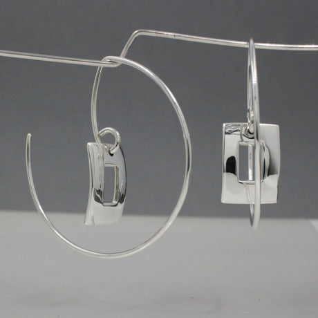 Artemis - Small Off-Center Rectangle Reverse Hoop Silver Earrings Curated and designed by Emilio Sotelo Jewelry for Croi Kinsale Jewellery in Kinsale West Cork Ireland Europe. Find exceptional handmade silver and gold jewellery at affordable prices for birthday gifts and Christmas presents. Handcrafted Silver jewelry. The best affordable jewellery