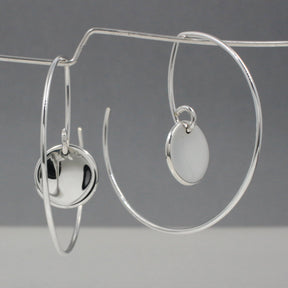 Selene - Small Dapped Disc Reverse Hoop Silver Earrings Curated and designed by Emilio Sotelo Jewelry for Croi Kinsale Jewellery in Kinsale West Cork Ireland Europe. Find exceptional handmade silver and gold jewellery at affordable prices for birthday gifts and Christmas presents. Handcrafted Silver jewelry. The best affordable jewellery