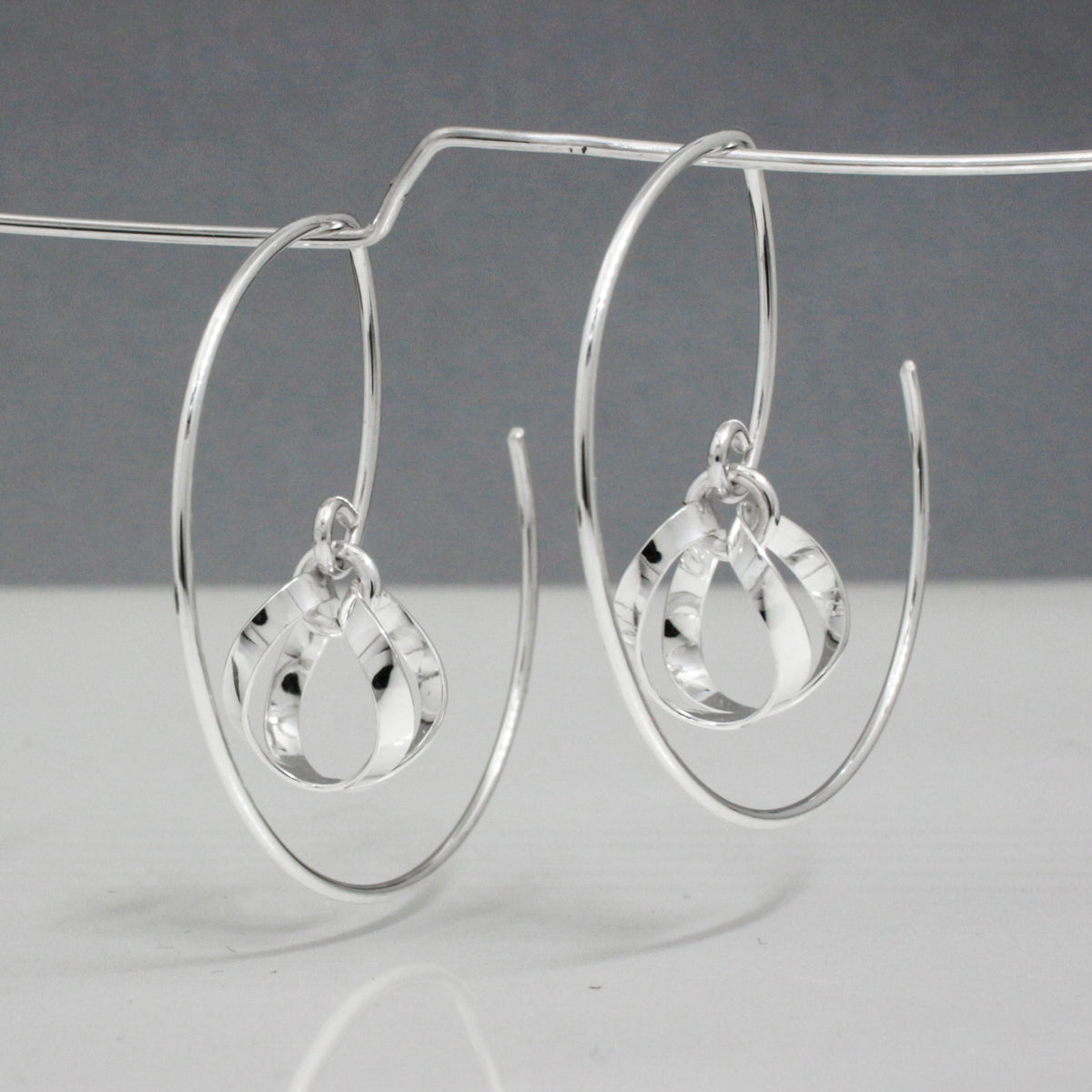 AYA - Dew Drop Reverse Hoop Silver Earrings Curated and designed by Emilio Sotelo Jewelry for Croi Kinsale Jewellery in Kinsale West Cork Ireland Europe. Find exceptional handmade silver and gold jewellery at affordable prices for birthday gifts and Christmas presents. Handcrafted Silver jewelry. The best affordable jewellery