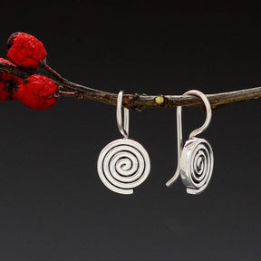 Aran - Swirl Disc Silver Earrings - Dangle Curated and designed by Emilio Sotelo Jewelry for Croi Kinsale Jewellery in Kinsale West Cork Ireland Europe. Find exceptional handmade silver and gold jewellery at affordable prices for birthday gifts and Christmas presents. Handcrafted Silver jewelry. Find the best affordable jewellery