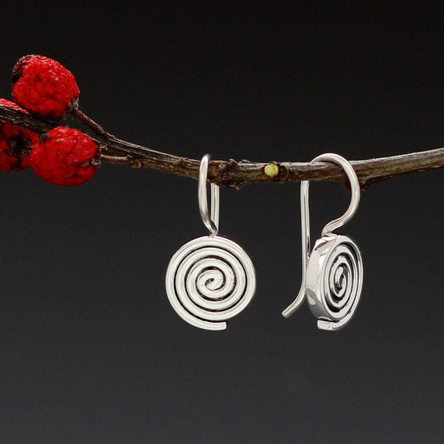 Aran - Swirl Disc Silver Earrings - Dangle Curated and designed by Emilio Sotelo Jewelry for Croi Kinsale Jewellery in Kinsale West Cork Ireland Europe. Find exceptional handmade silver and gold jewellery at affordable prices for birthday gifts and Christmas presents. Handcrafted Silver jewelry. Find the best affordable jewellery