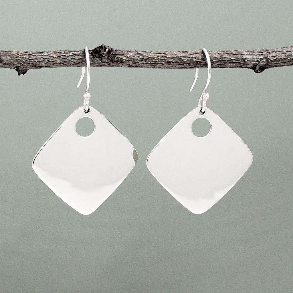 Nathalia - Rhombus Off-Center Dot Silver Earrings. With dimensions of 29mm long by 29mm wide, or roughly 1 1/4 inches square, they make a bold yet elegant statement. The off-center dot design adds a unique flair to their high polished finish.