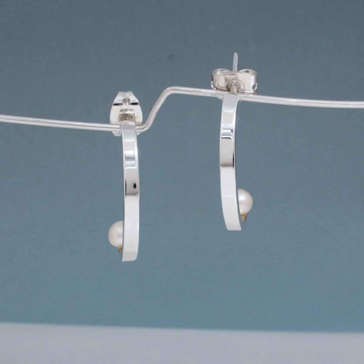 Artemis - Small Half Hoop Pearl Silver Earrings - Stud Curated and designed by Emilio Sotelo Jewelry for Croi Kinsale Jewellery in Kinsale West Cork Ireland Europe. Find exceptional handmade silver and gold jewellery at affordable prices for birthday gifts and Christmas presents. Handcrafted Silver jewelry. Find the best affordable jewellery